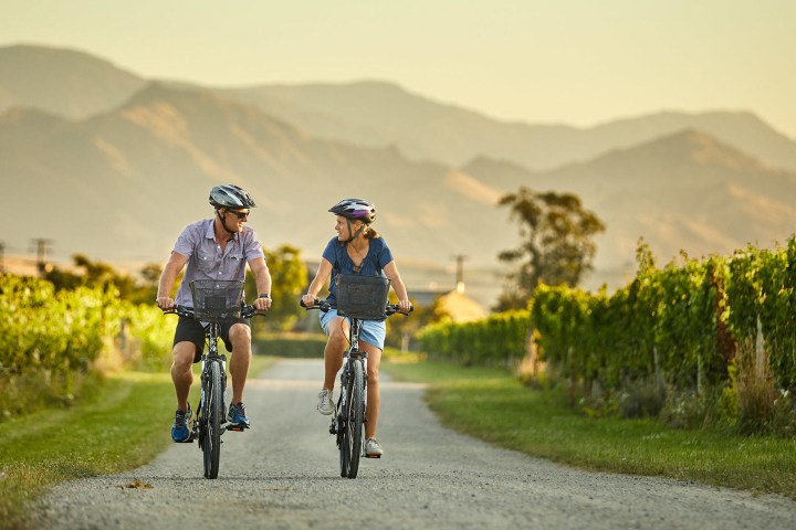 a man riding a bike down a dirt road